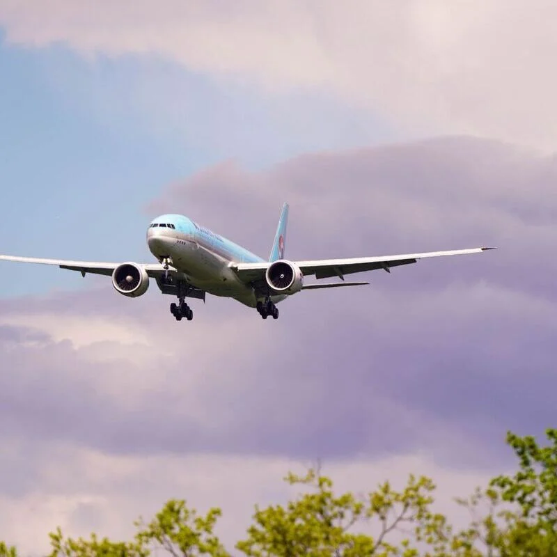 Boeing 777-385ER in front of purple clouds