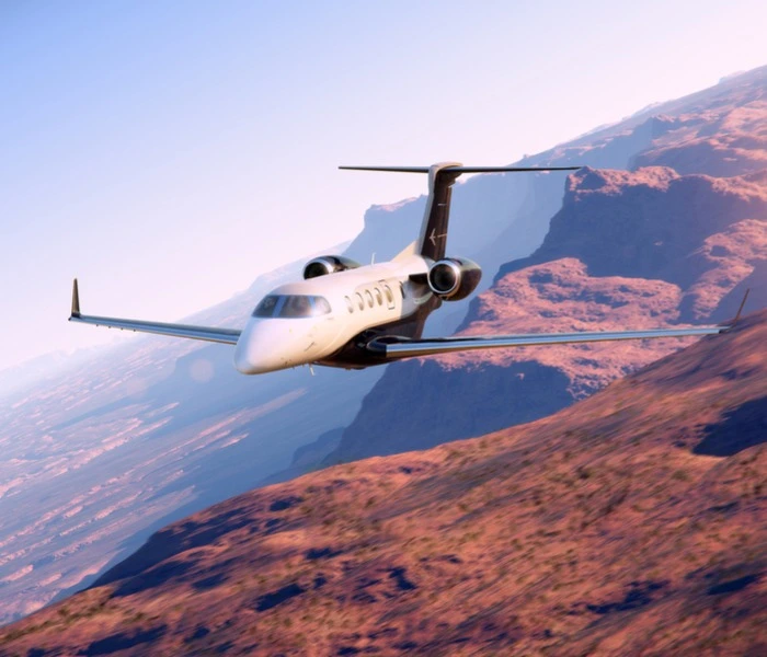 In flight Phenom 300 with red background