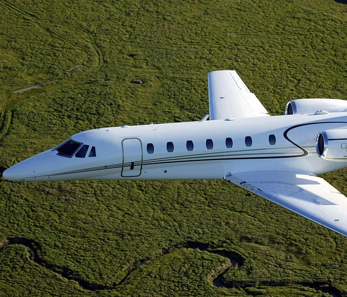 flying citation sovereign with green background
