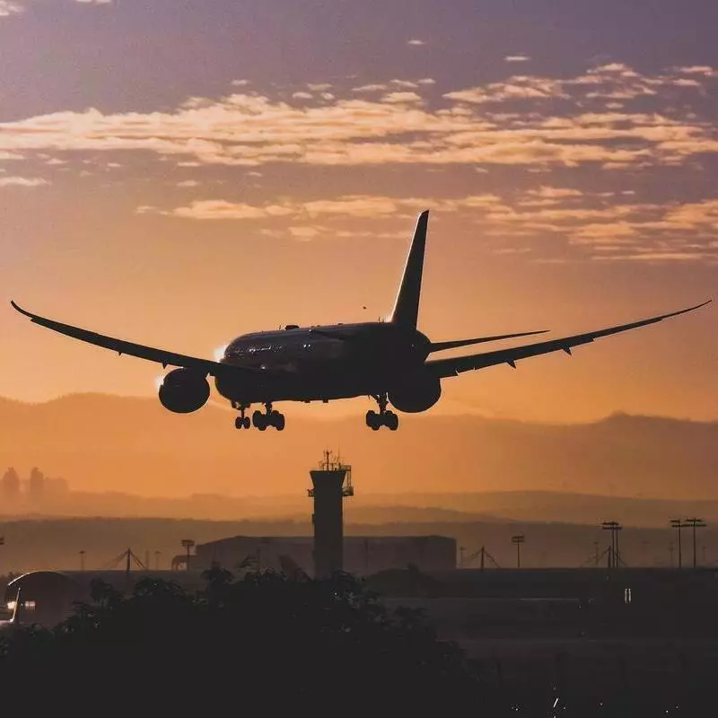 landing at airport with sunset and Boeing 777